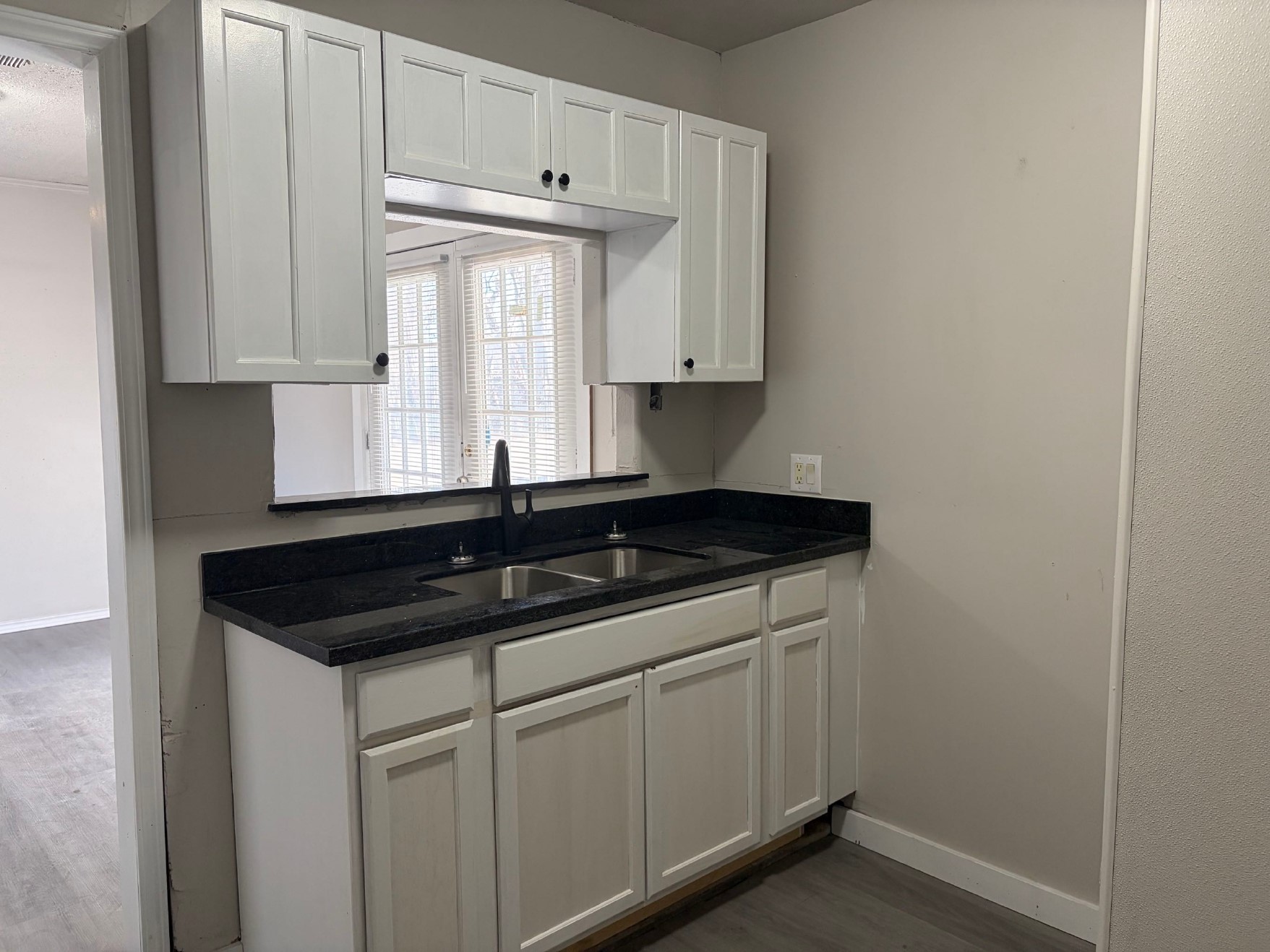 5406 Lyndhurst Drive Houston, TX 77033 - Photo 6 of 17 a kitchen with granite countertop white cabinets and a sink