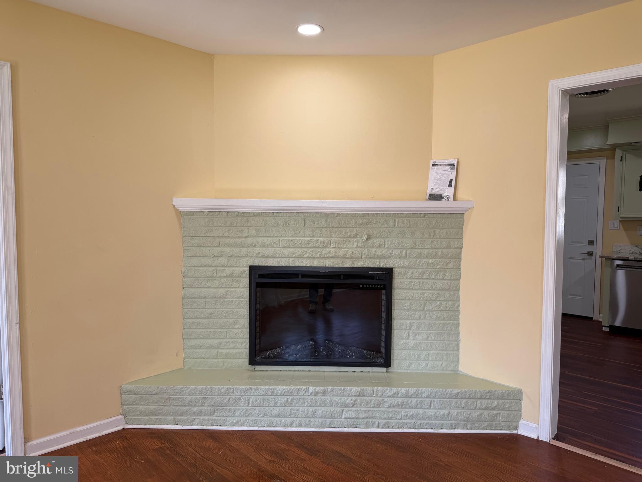 19124 Longmeadow Road Hagerstown, MD 21742 - Photo 6 of 23 a living room with a fireplace and a wooden floor