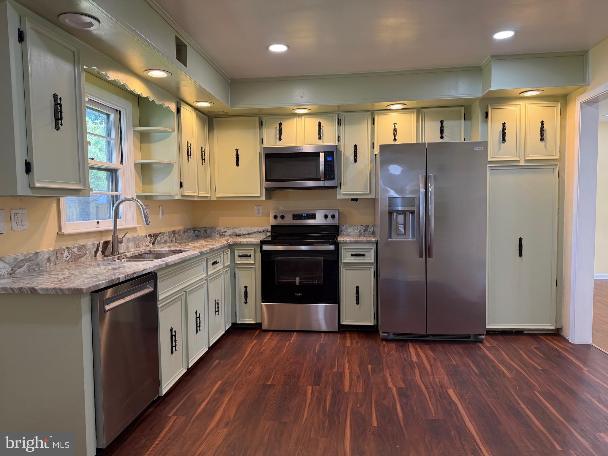 19124 Longmeadow Road Hagerstown, MD 21742 - Photo 10 of 23 a kitchen with a refrigerator a sink and dishwasher with wooden floor