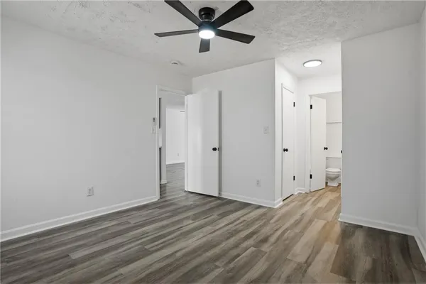 a view of empty room with wooden floor