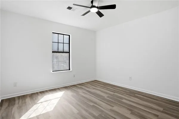 wooden floor in an empty room with a window