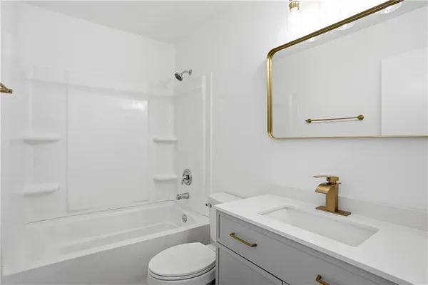 a bathroom with a sink a toilet and bathtub