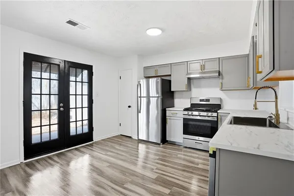 a kitchen with stainless steel appliances granite countertop a stove and a refrigerator