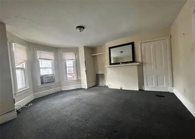 an empty room with windows and closet