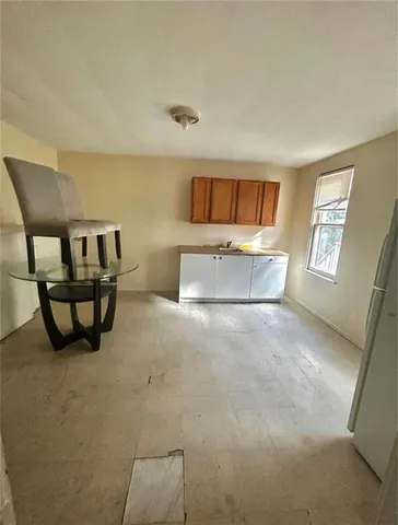 a spacious bedroom with a bed and window