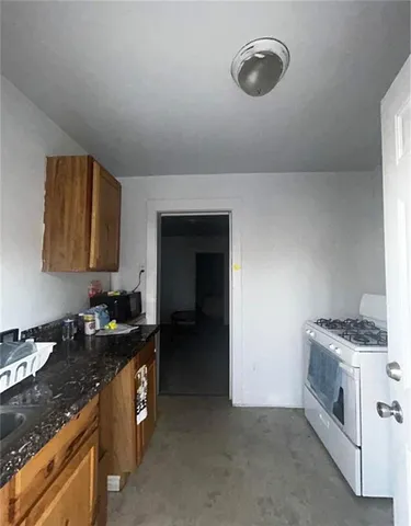 a kitchen with a sink and a stove top oven
