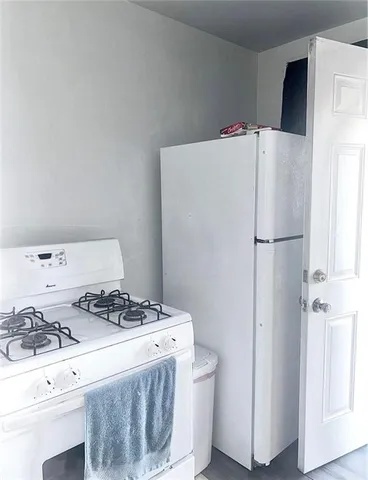 a white refrigerator freezer sitting inside of a kitchen