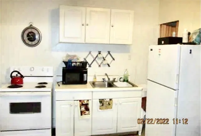 a kitchen with a refrigerator and a stove