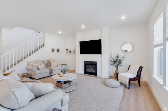 2664 West Maple Street Mapleton, UT 84664 - Photo 2 of 49 Open concept living area featuring light wood-finish flooring, recessed lighting, and a prominent fireplace with a television mount above