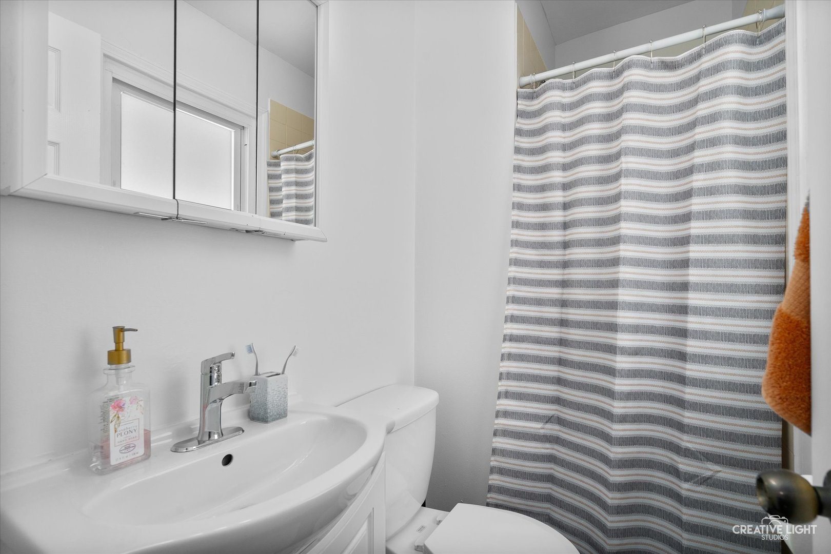 125 South Pinecrest Road Bolingbrook, IL 60440 - Photo 16 of 22 a bathroom with a sink a toilet and mirror