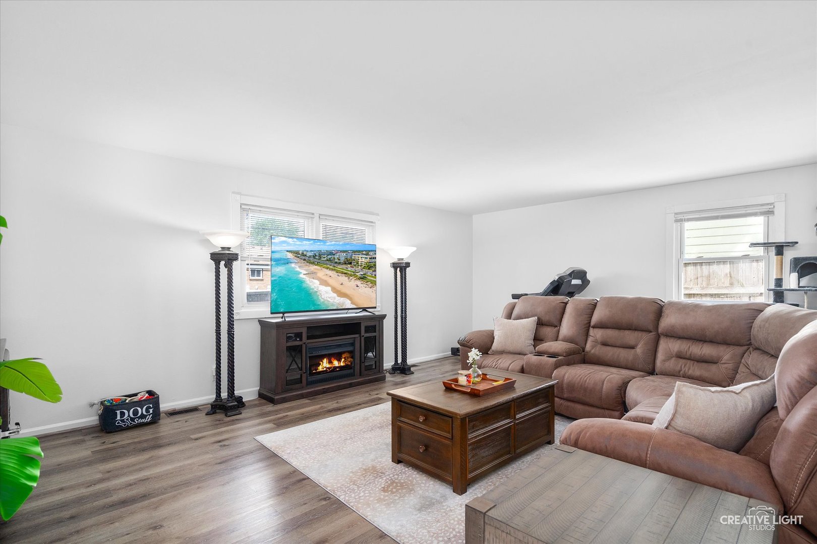 125 South Pinecrest Road Bolingbrook, IL 60440 - Photo 2 of 22 a living room with furniture a flat screen tv and a fireplace