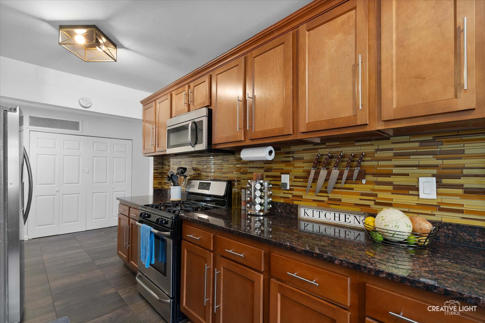 125 South Pinecrest Road Bolingbrook, IL 60440 - Photo 9 of 22 a kitchen with stainless steel appliances granite countertop a stove a sink and a microwave