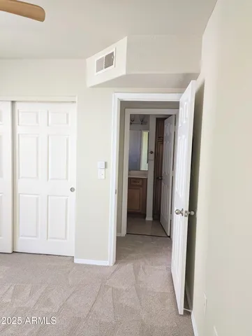 a view of a hallway with closet and wooden floor