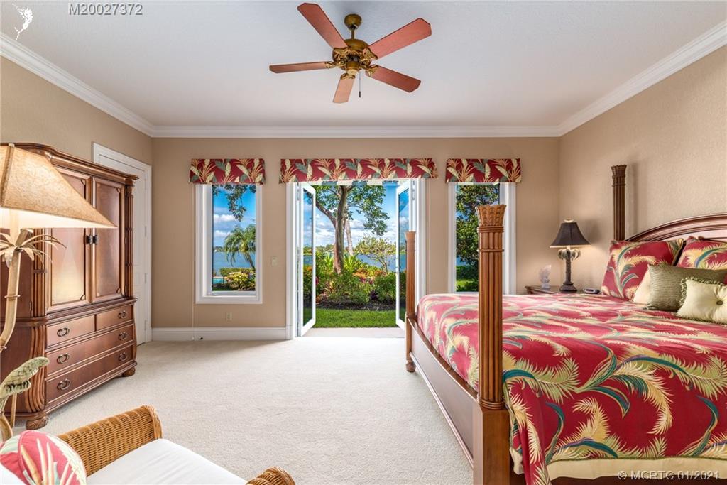 11 West High Point Road Stuart, FL 34996 - Photo 15 of 25 a bedroom with a bed and a large window