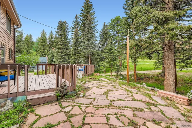 a view of a house with yard and a garden