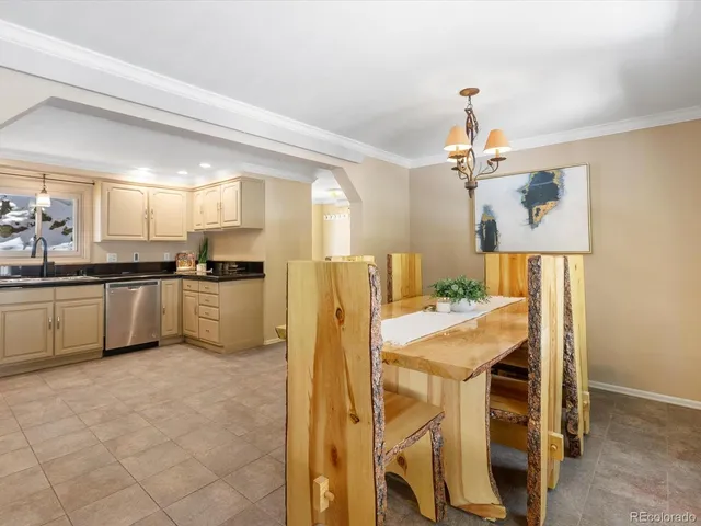 a living room with stainless steel appliances kitchen island granite countertop furniture a rug and a window