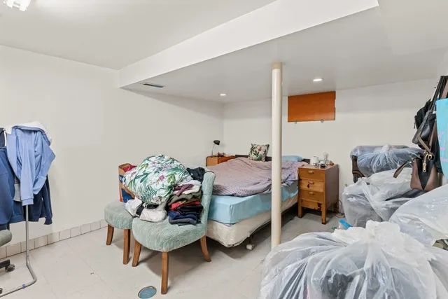 a bed room with a bed furniture and a chair