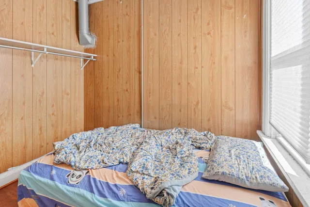 a bedroom with a bed and a window