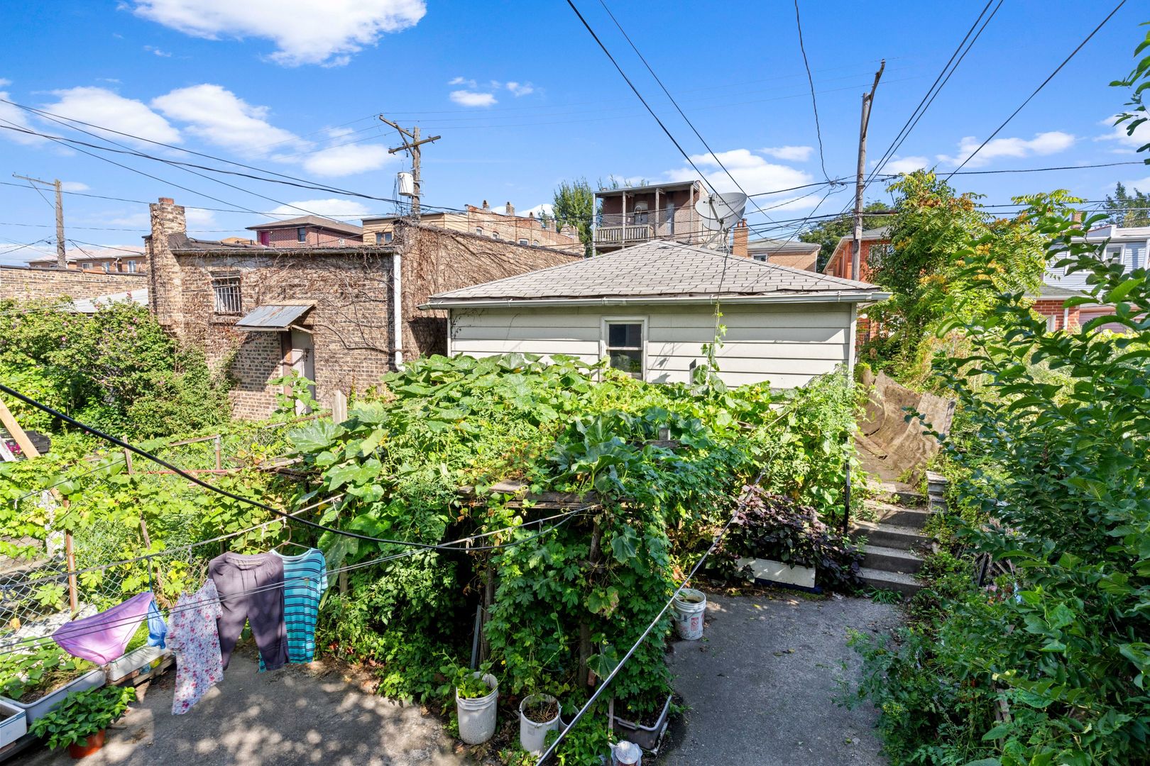 318 West 24th Place Chicago, IL 60616 - Photo 21 of 21 a view of a white house with a big yard and potted plants