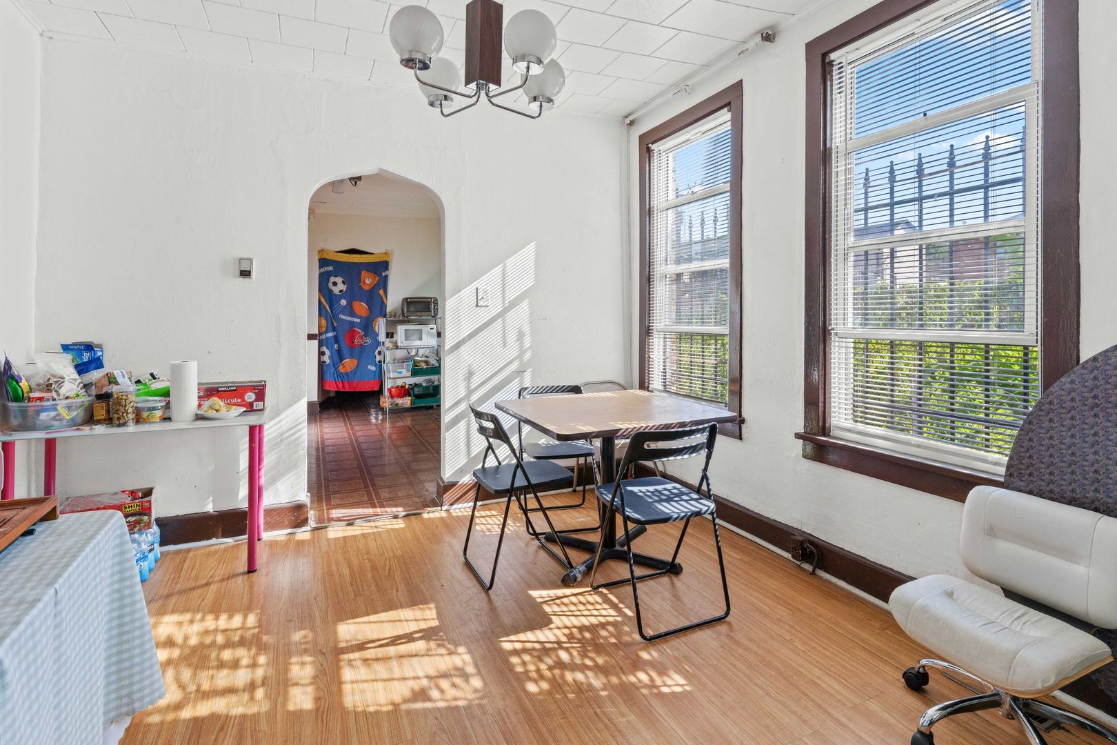 318 West 24th Place Chicago, IL 60616 - Photo 3 of 21 a dining room with furniture a chandelier and wooden floor