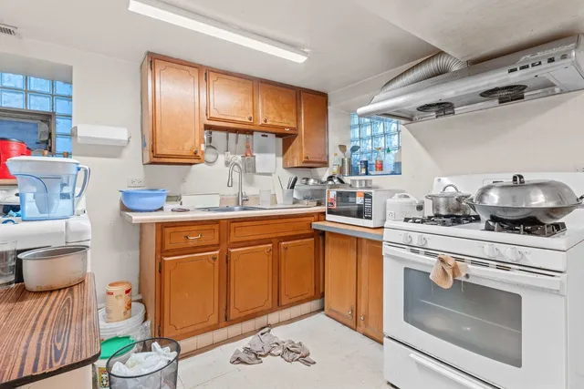 a kitchen with a sink stove and cabinets