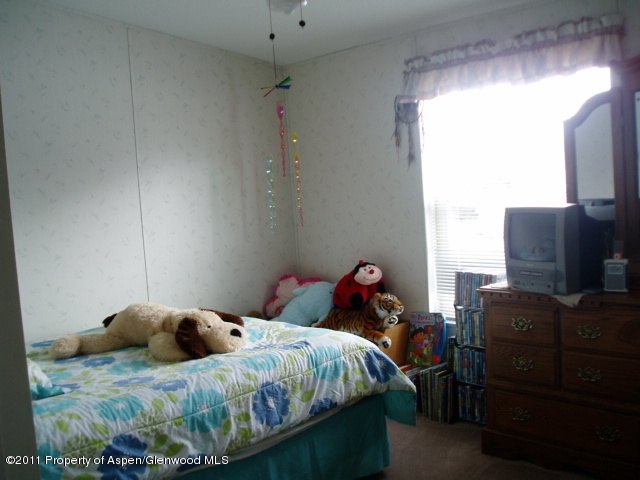 659 Park Avenue Rifle, CO 81650 - Photo 11 of 15 a bed room with a bed and a television