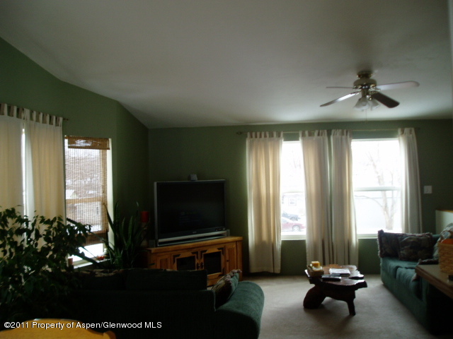 659 Park Avenue Rifle, CO 81650 - Photo 3 of 15 a living room with furniture and a flat screen tv
