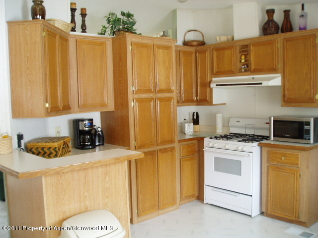 659 Park Avenue Rifle, CO 81650 - Photo 5 of 15 a kitchen with a sink a stove and cabinets