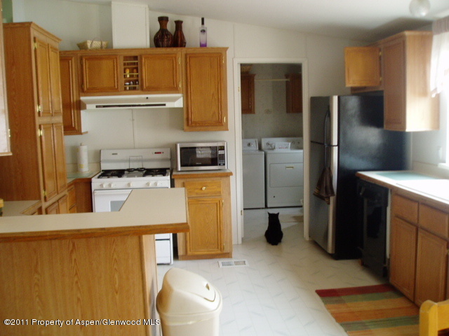 659 Park Avenue Rifle, CO 81650 - Photo 6 of 15 a kitchen with a refrigerator a stove and a refrigerator