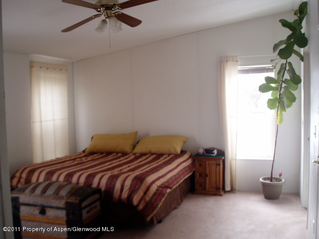 659 Park Avenue Rifle, CO 81650 - Photo 8 of 15 a bedroom with a bed and a window