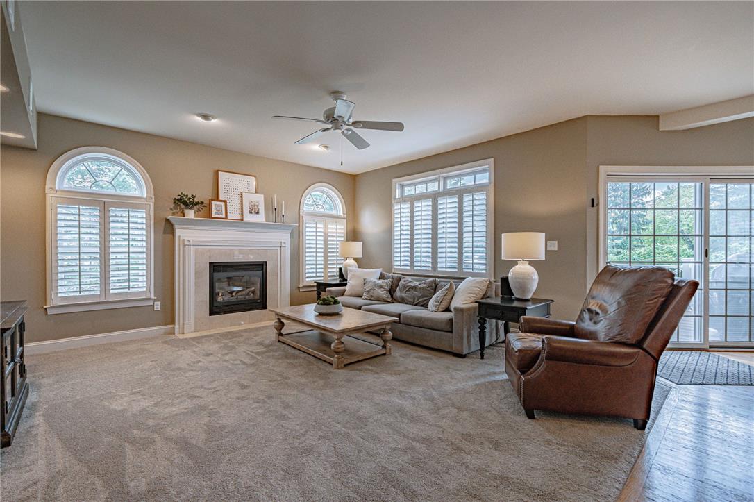 6000 Pond View Terrace Bath, PA 18014 - Photo 29 of 69 A refined living space features a cozy gas fireplace, abundant natural light, and access to outdoor views.