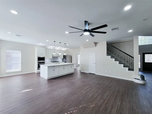 a bathroom with a granite countertop sink a toilet and bathtub