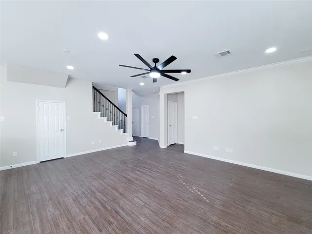 a view of a hallway with a large window and wooden floor