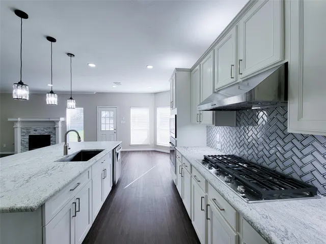 a kitchen with stainless steel appliances granite countertop a stove and a refrigerator