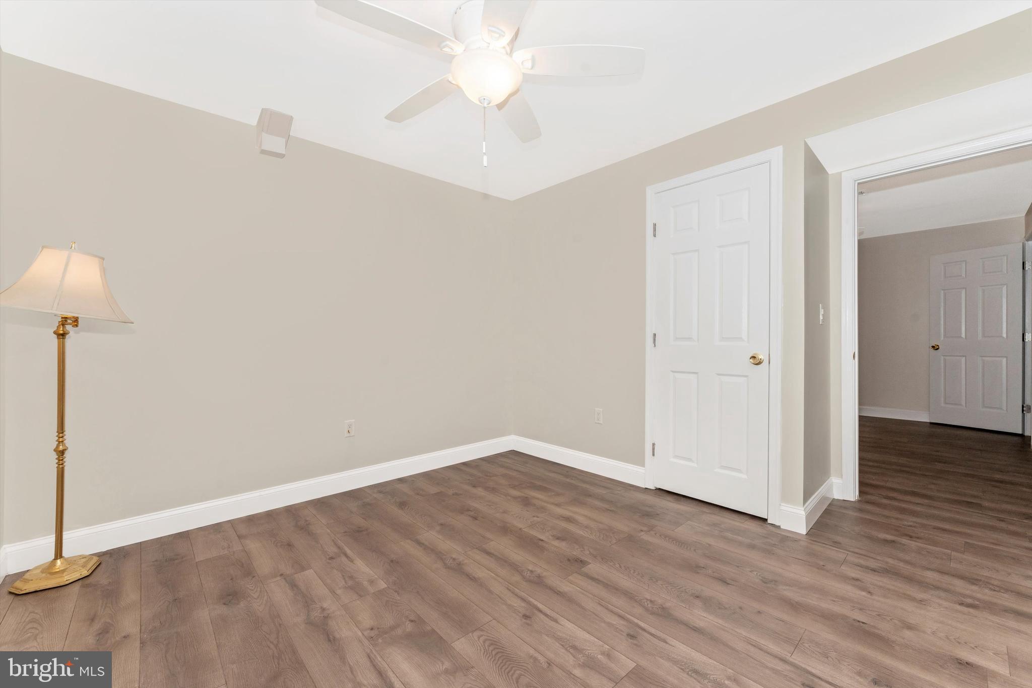 4216 Sykesville Road, Unit B Finksburg, MD 21048 - Photo 19 of 27 an empty room with wooden floor and fan