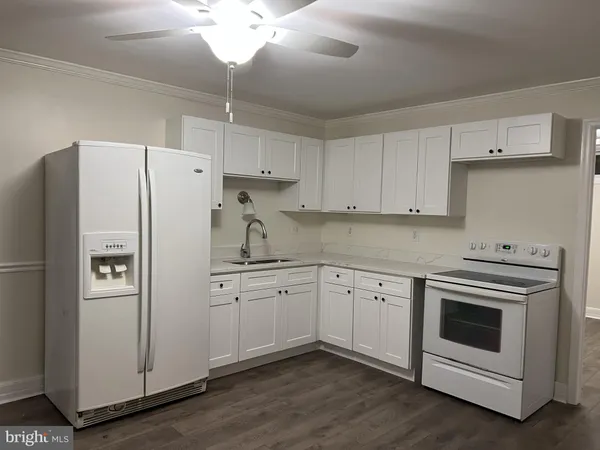 a kitchen with cabinets stainless steel appliances and a counter space