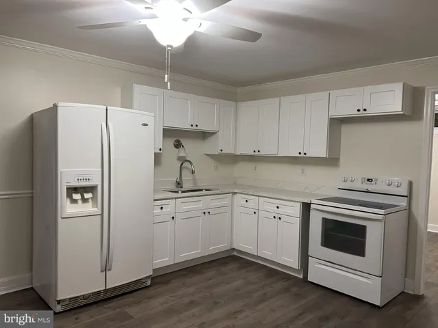 a kitchen with cabinets stainless steel appliances and a counter space
