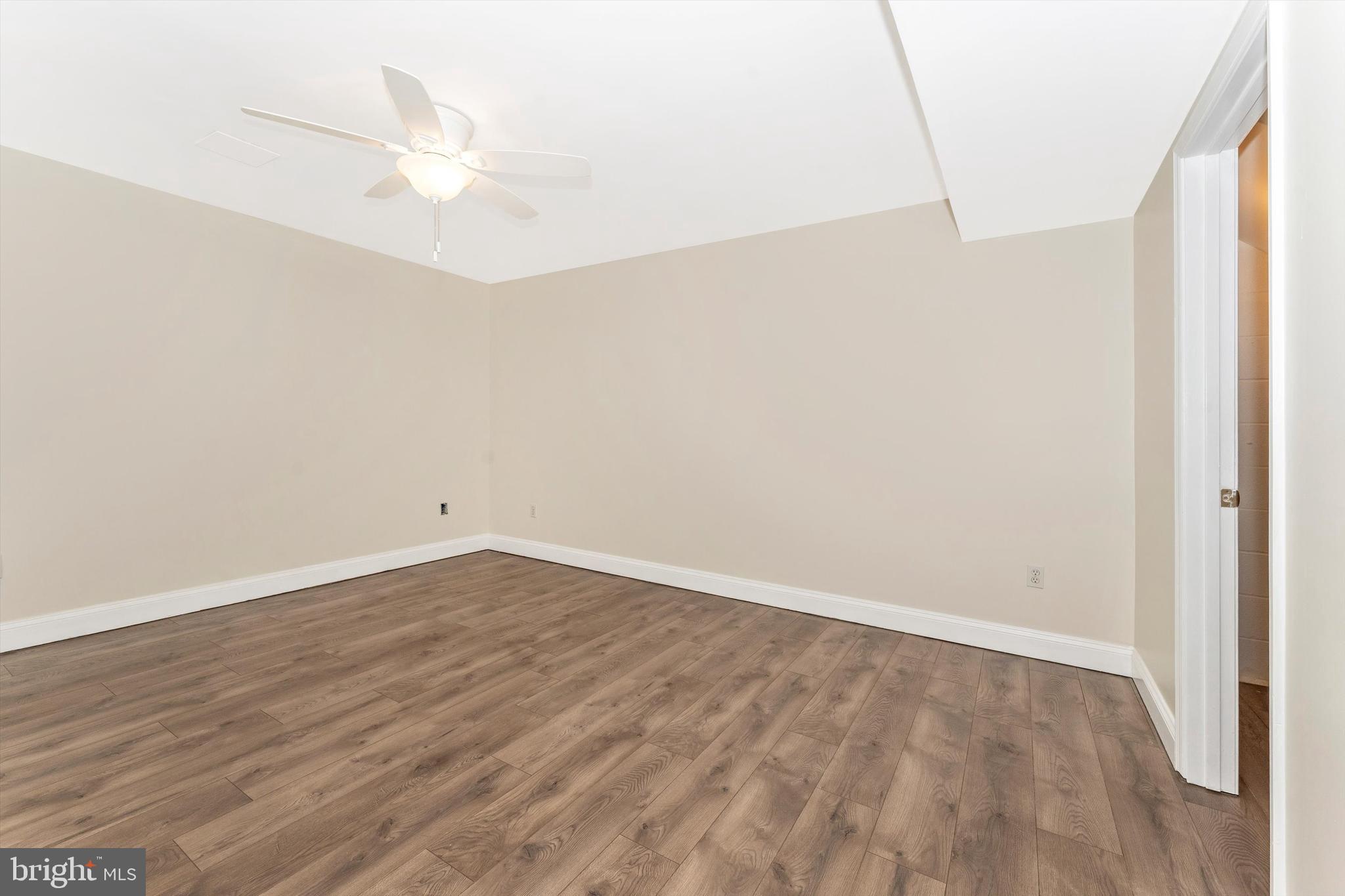 4216 Sykesville Road, Unit B Finksburg, MD 21048 - Photo 10 of 27 an empty room with wooden floor and fan