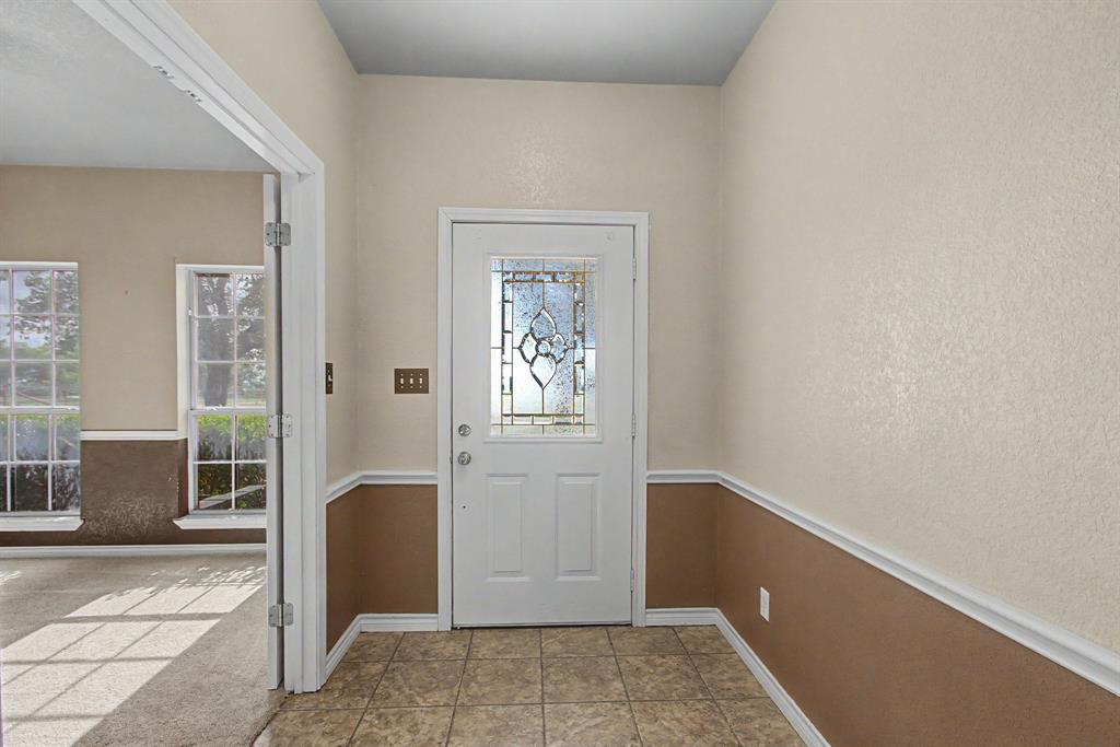 483 Christy Kay Lane Rhome, TX 76078 - Photo 5 of 40 a view of an entryway with wooden floor and cabinet