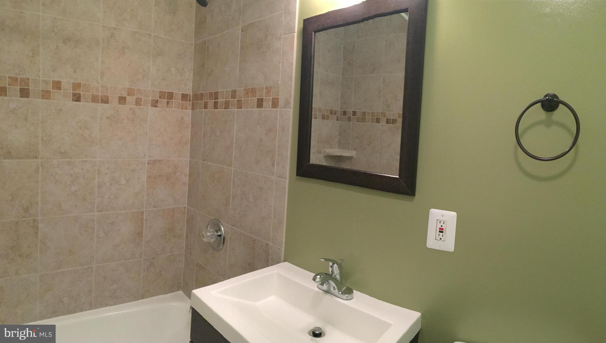 2356 Southgate Square Reston, VA 20191 - Photo 14 of 18 a bathroom with a sink mirror and shower