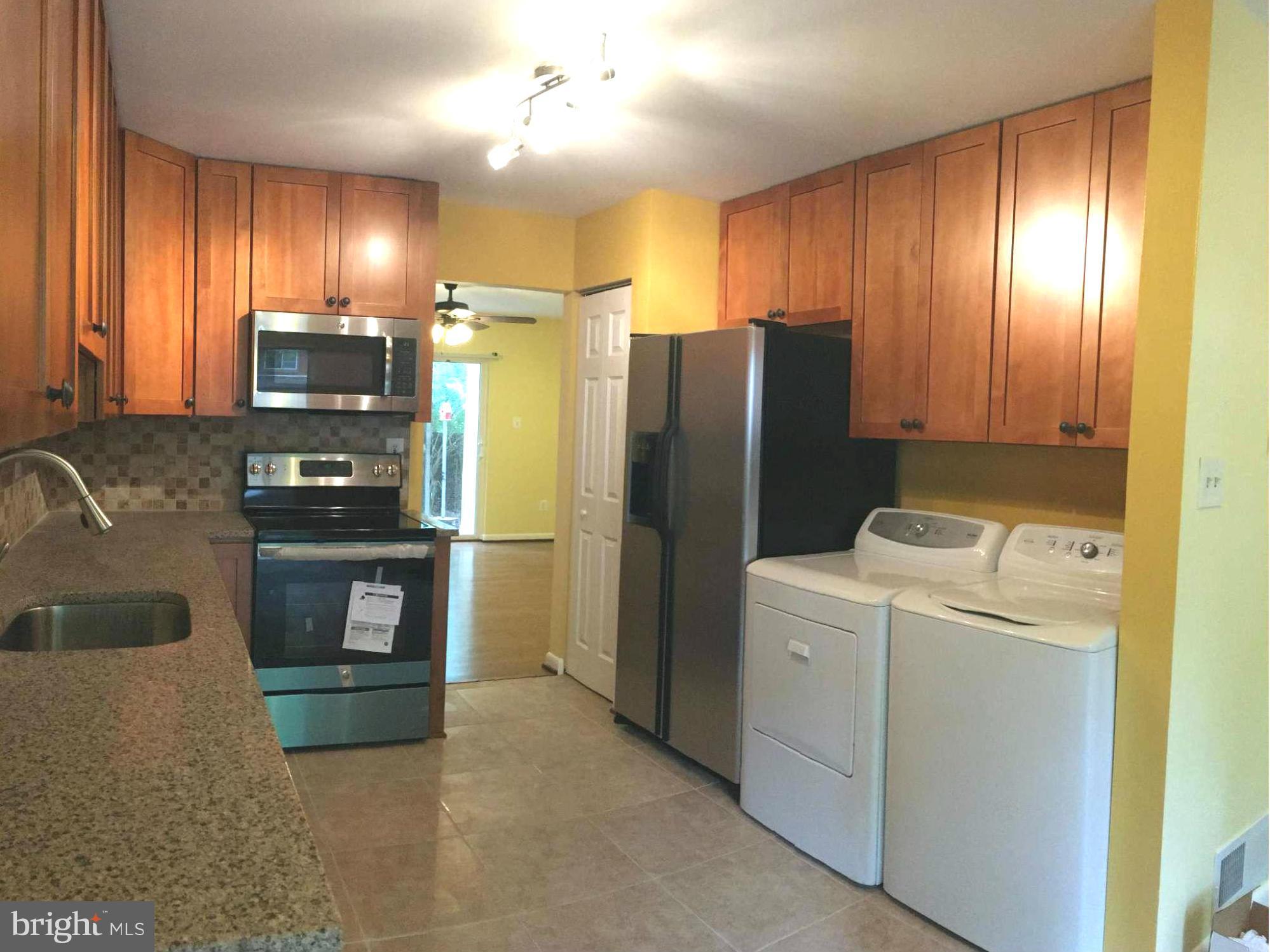 2356 Southgate Square Reston, VA 20191 - Photo 3 of 18 a kitchen with a refrigerator and a stove top oven
