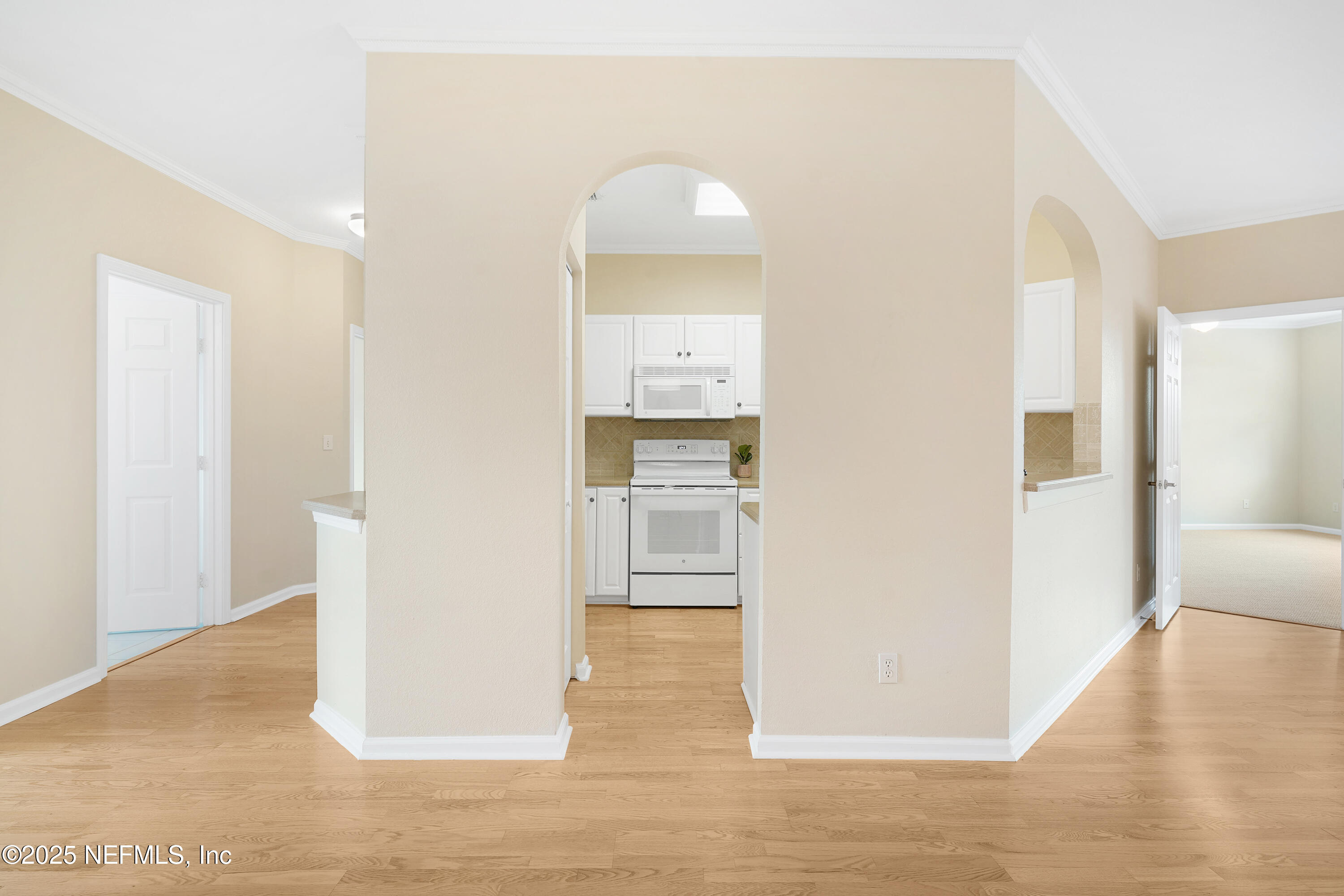 2827 Vista Cove Road St. Augustine, FL 32084 - Photo 11 of 59 a view of a hallway with wooden floor and a living room