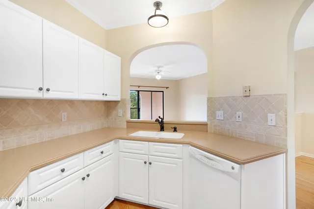 an empty room with a ceiling fan and a window