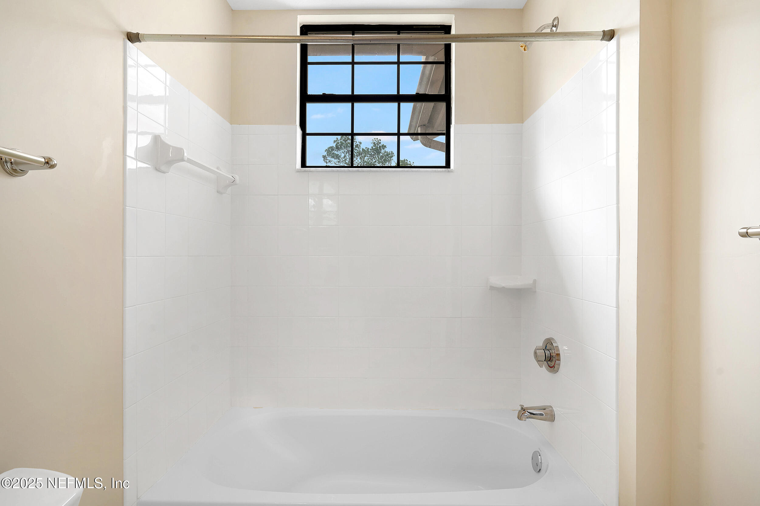 2827 Vista Cove Road St. Augustine, FL 32084 - Photo 27 of 59 a bathroom with a bathtub and window