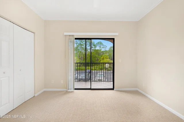 a view of an empty room with a kitchen