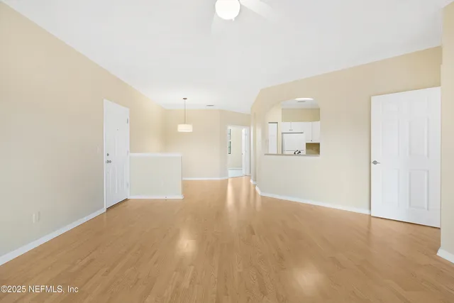a view of a room with a window and wooden floor