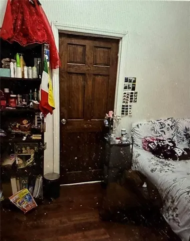 a bedroom with a bed and a mirror