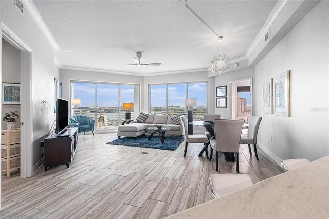 a living room with furniture a fireplace a flat screen tv and a window