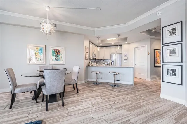 a living room with kitchen island furniture and a chandelier