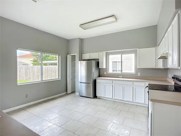 a kitchen with a refrigerator and a sink
